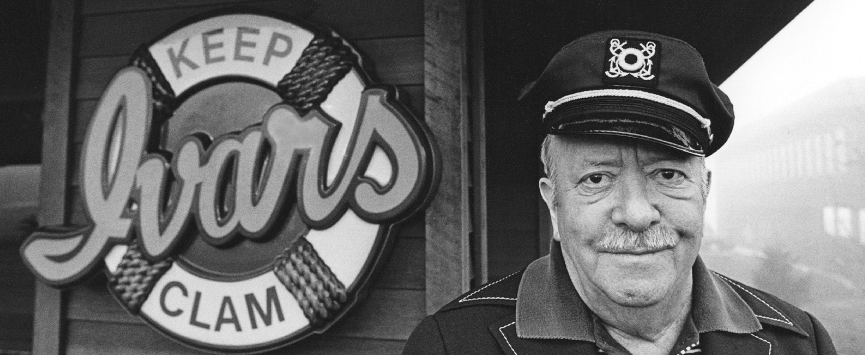 Old black and white photo of Ivar Haglund in front of restaurant