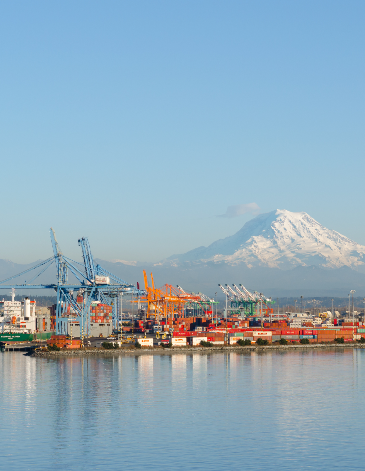 Port of Seattle cranes and shipping containers with Mount Rainier in the distance