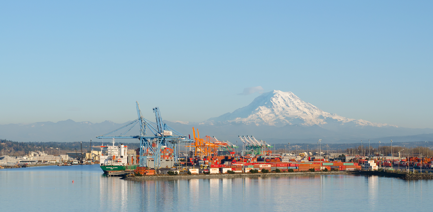 Port of Seattle cranes and shipping containers with Mount Rainier in the distance