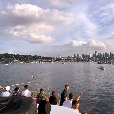 Mentor Creative Group team enjoying the view of the Seattle skyline from Aaron's boat deck
