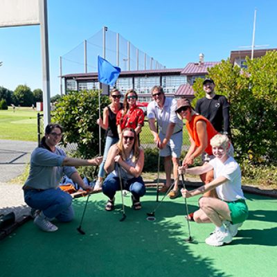 Mentor Creative Group team posing at the Interbay Golfing Center