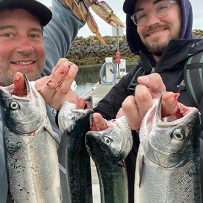 Aaron and Evan showing off the fish they caught on Aaron's boat