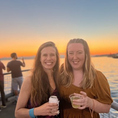 Britt and Lilly attending a Seattle waterfront event at sunset